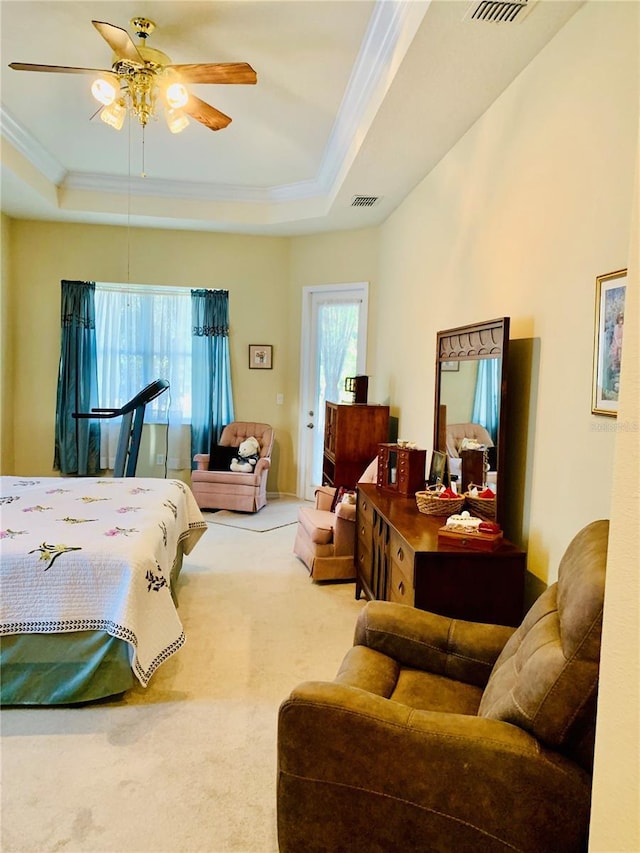 bedroom with ceiling fan, a raised ceiling, carpet floors, and multiple windows