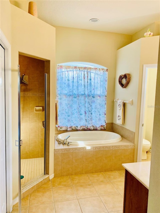 bathroom featuring vanity, independent shower and bath, and tile patterned flooring