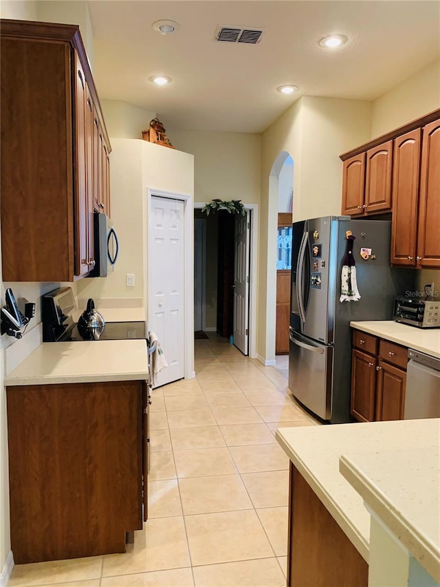 kitchen with stainless steel appliances and light tile patterned floors