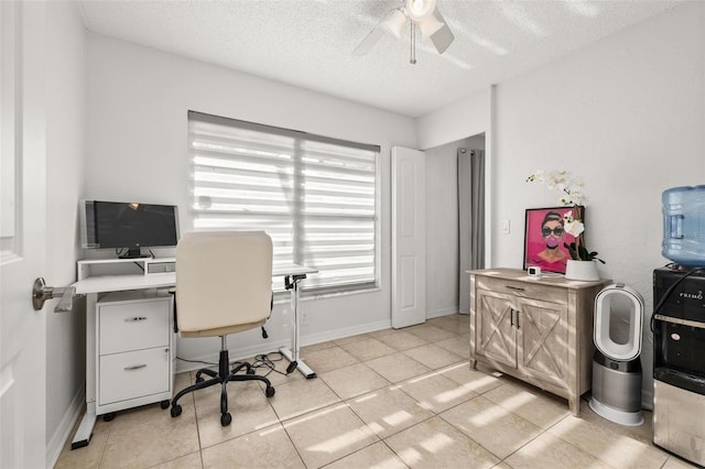 tiled home office featuring ceiling fan and a textured ceiling