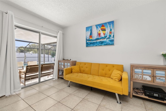 living area featuring tile patterned flooring and a textured ceiling