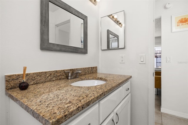 bathroom with tile patterned flooring and vanity