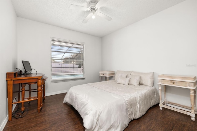 bedroom with a textured ceiling, ceiling fan, and dark wood-type flooring