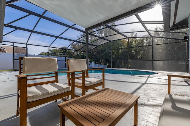 view of pool with a patio and glass enclosure