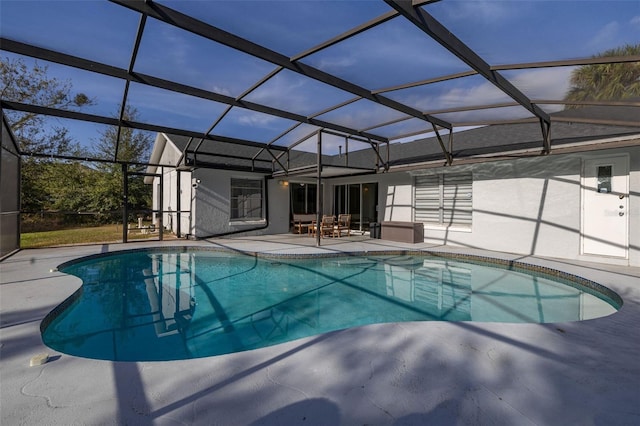 view of swimming pool with glass enclosure and a patio area