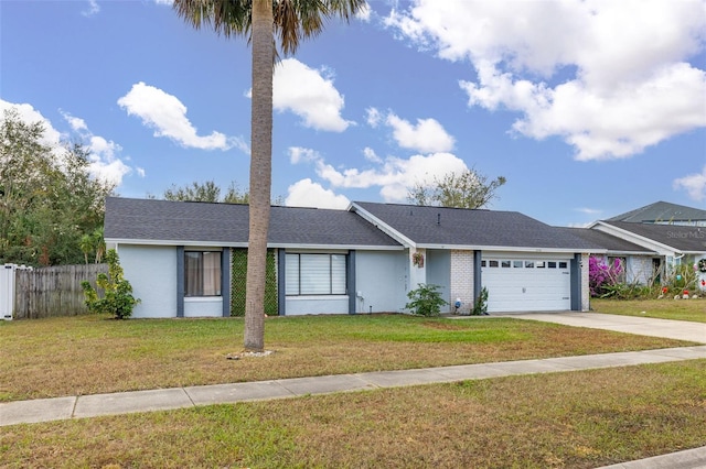 ranch-style house with a garage and a front lawn