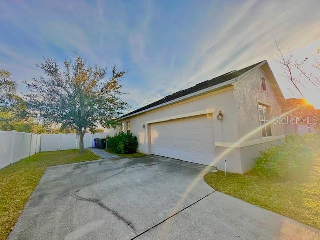 view of home's exterior featuring a garage and a lawn