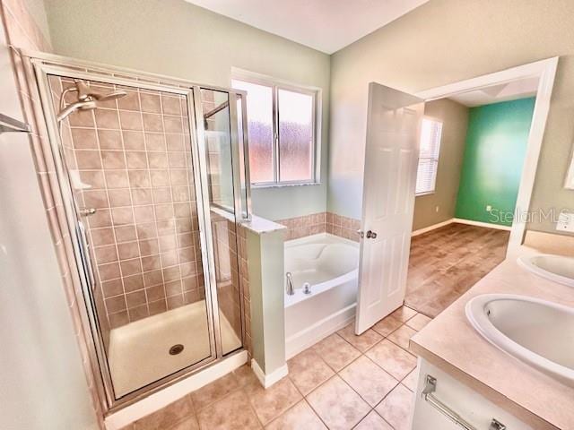 bathroom with tile patterned floors, vanity, and separate shower and tub