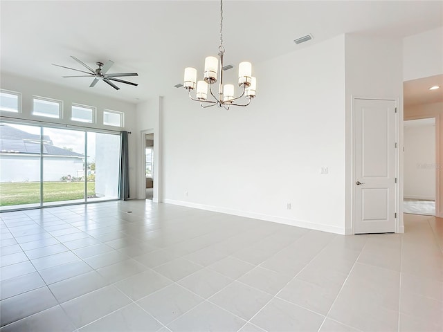 tiled empty room with ceiling fan with notable chandelier