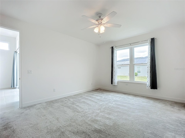 carpeted empty room featuring ceiling fan