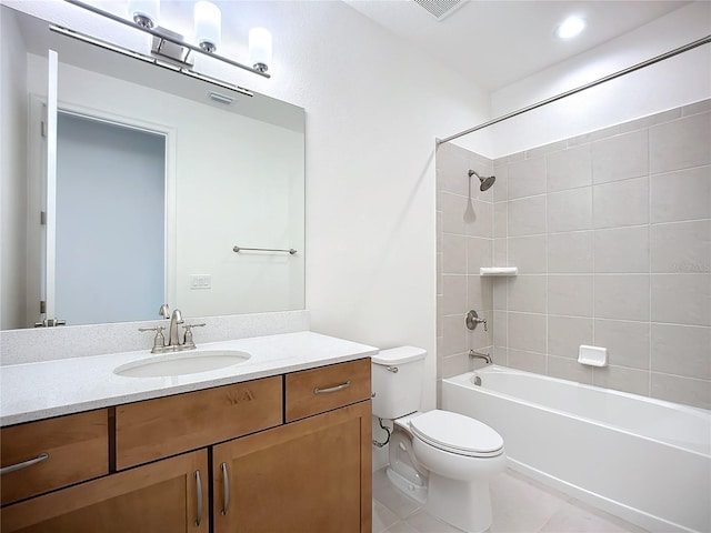 full bathroom with tile patterned floors, tiled shower / bath combo, toilet, and vanity