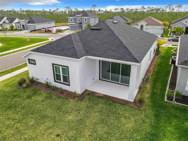 rear view of property with a yard and a patio