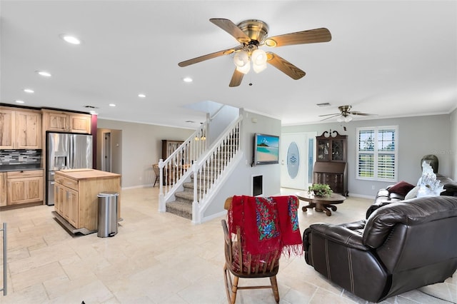 living room featuring crown molding and ceiling fan