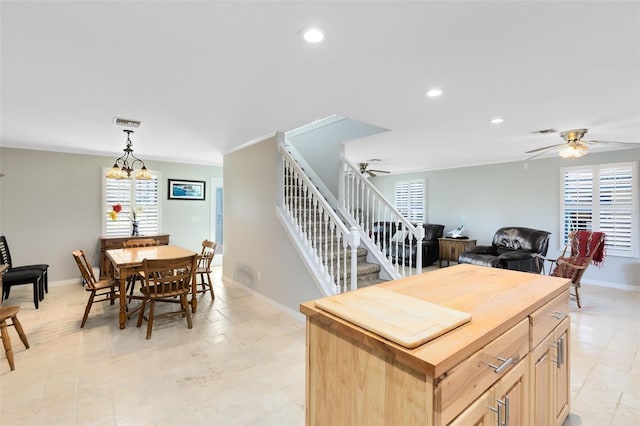 2545 Harris Blvd, Kissimmee, FL 34746 - kitchen with ceiling fan, recessed lighting, light brown cabinetry, butcher block countertops, and a center island