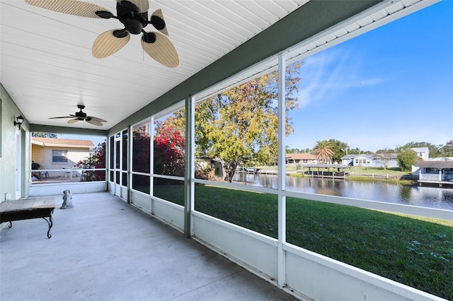 2545 Harris Blvd, Kissimmee, FL 34746 - unfurnished sunroom featuring a water view, a ceiling fan, and a residential view