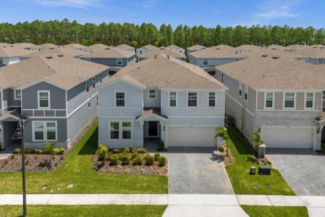 4141 Lana Ave, Davenport, FL 33897 - view of front of house featuring a garage, decorative driveway, and a residential view