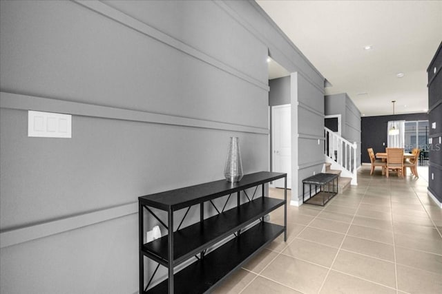 4141 Lana Ave, Davenport, FL 33897 - hall featuring light tile patterned floors, stairway, and a decorative wall