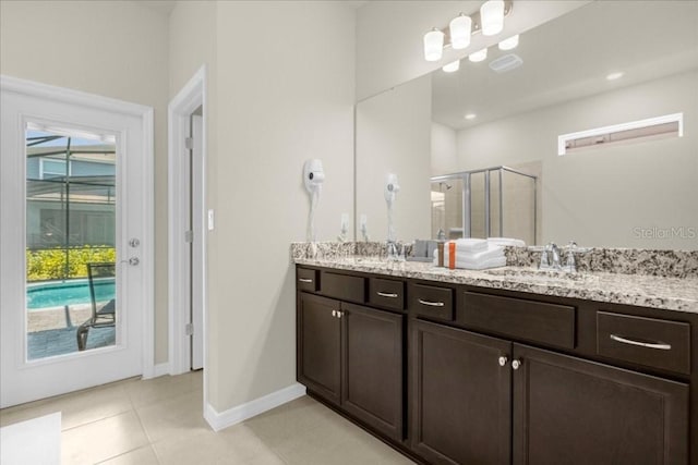 4141 Lana Ave, Davenport, FL 33897 - bathroom featuring a shower stall, double vanity, tile patterned floors, and healthy amount of natural light