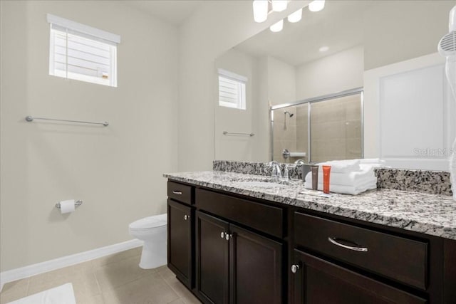 bathroom featuring walk in shower, tile patterned flooring, vanity, and toilet