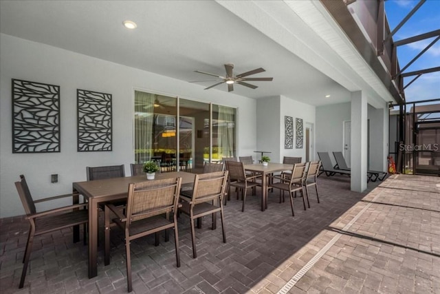 view of patio / terrace featuring ceiling fan and a lanai