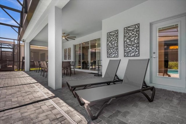 4141 Lana Ave, Davenport, FL 33897 - view of patio featuring outdoor dining space, ceiling fan, and glass enclosure