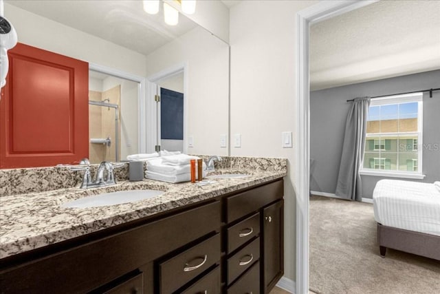 bathroom with a shower with door and vanity