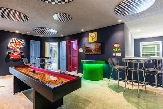 game room featuring carpet and a textured ceiling