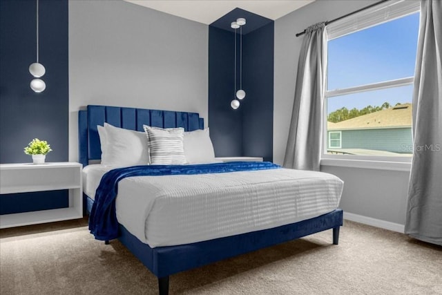 carpeted bedroom featuring multiple windows