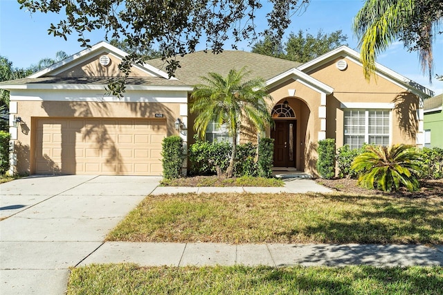 ranch-style home featuring a garage and a front lawn