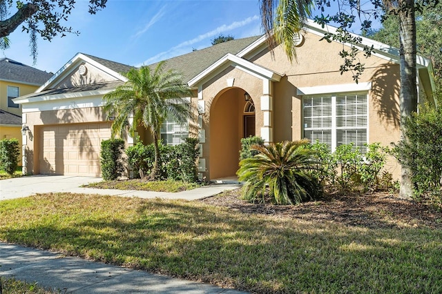 view of front of property featuring a garage and a front yard