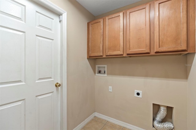 washroom featuring light tile patterned flooring, cabinets, washer hookup, and hookup for an electric dryer