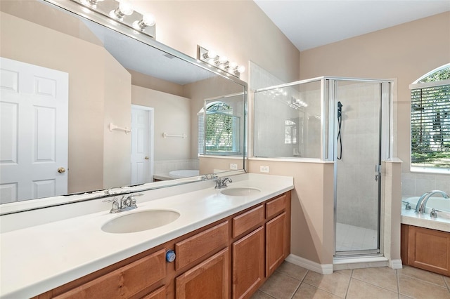 bathroom featuring independent shower and bath, vanity, tile patterned flooring, and a wealth of natural light