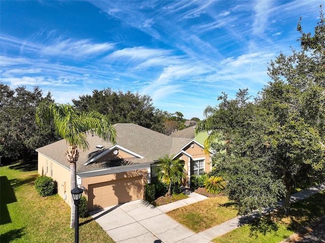 view of front of house with a garage and a front lawn