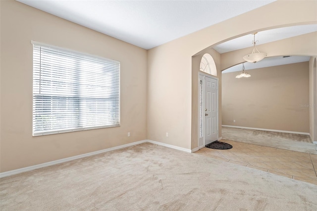 unfurnished room with light colored carpet