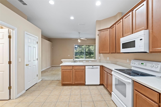 kitchen with sink, light tile patterned floors, ceiling fan, kitchen peninsula, and white appliances