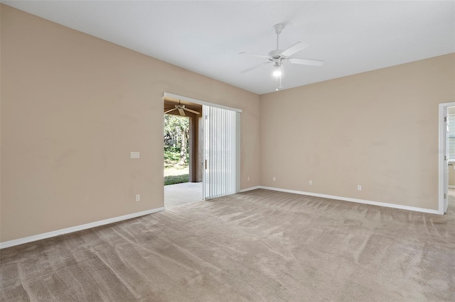 carpeted spare room with ceiling fan