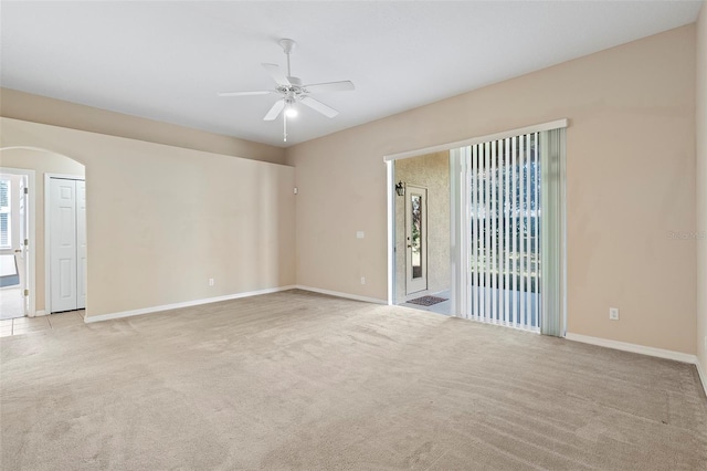 carpeted spare room featuring ceiling fan