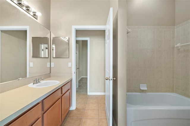 bathroom with tiled shower / bath combo, vanity, and tile patterned floors