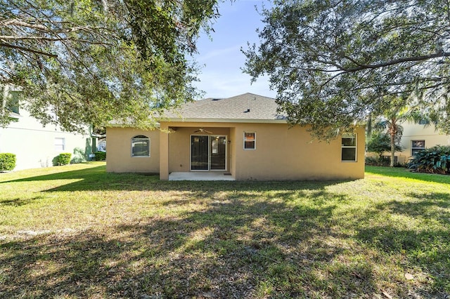 rear view of house featuring a yard and a patio area