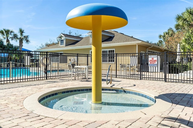 view of pool with a hot tub