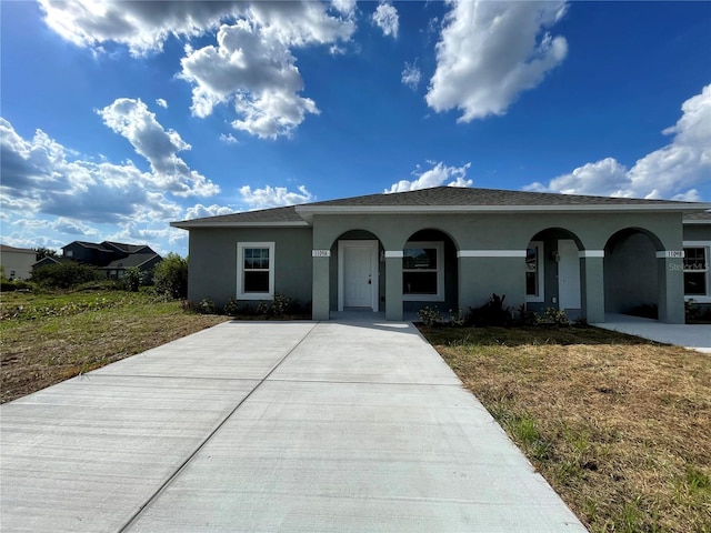 single story home with a front lawn and a porch