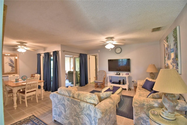 living room with ceiling fan and light tile patterned floors