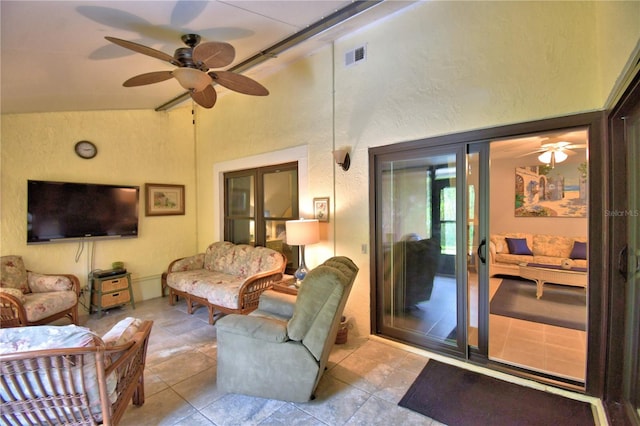 living room with ceiling fan and vaulted ceiling