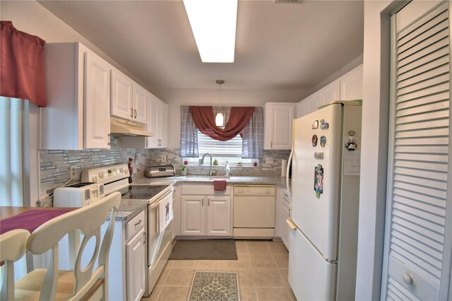 kitchen with pendant lighting, white appliances, white cabinets, sink, and light tile patterned flooring