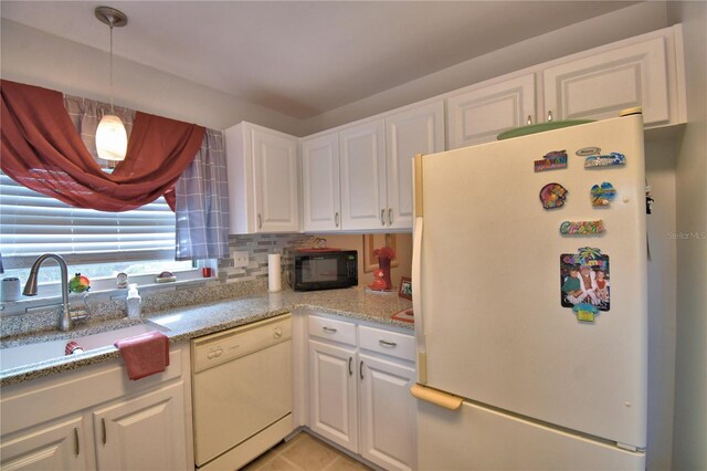 kitchen with sink, white appliances, white cabinetry, and pendant lighting