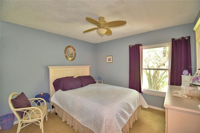 carpeted bedroom featuring a textured ceiling and ceiling fan