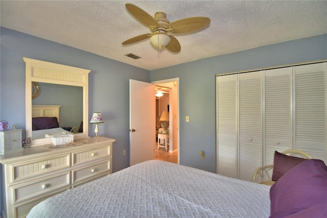 bedroom featuring ceiling fan, a textured ceiling, and a closet