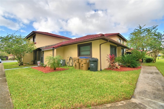 view of property exterior with a lawn