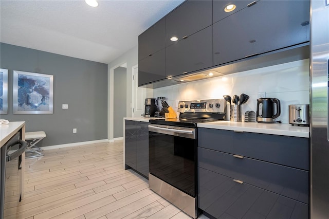 kitchen featuring decorative backsplash, appliances with stainless steel finishes, and light hardwood / wood-style flooring