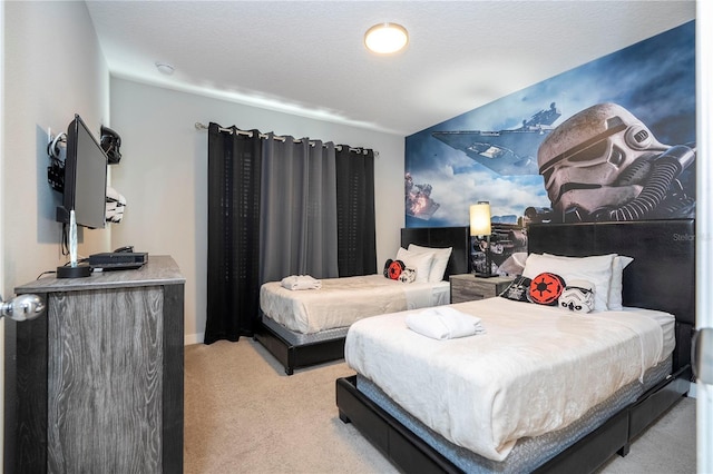 bedroom featuring a textured ceiling and light colored carpet